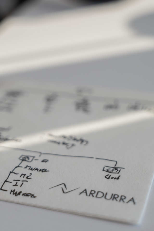Close-up of a hand-drawn systems diagram on paper with the Ardurra logo