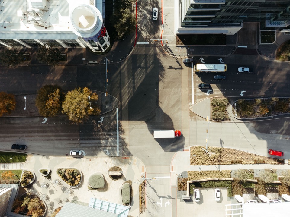 Aerial view of a sunlit downtown Dallas intersection