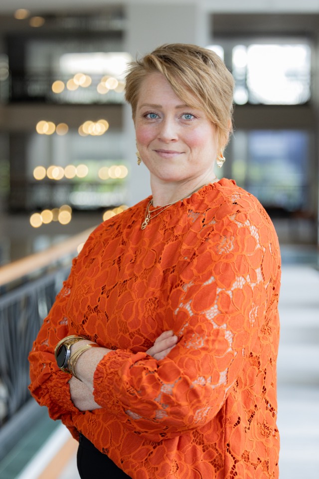 Environmental portrait of a leader in a bright office atrium