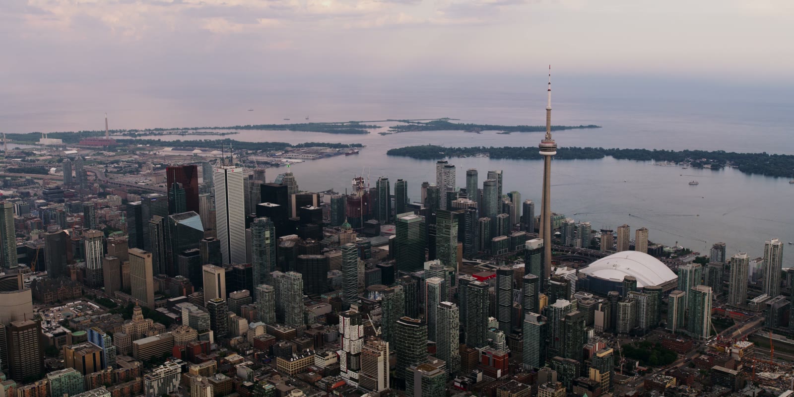Dusk aerial of a tower-studded skyline on the water, from the Introba brand hero film